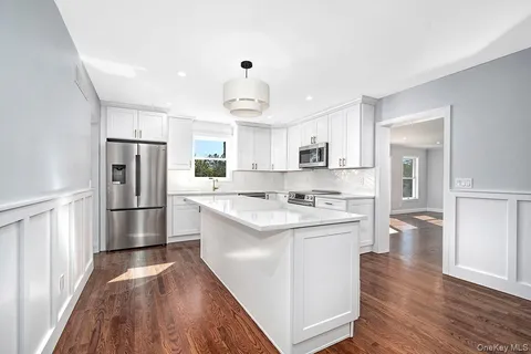 a kitchen with stainless steel appliances a refrigerator sink and cabinets
