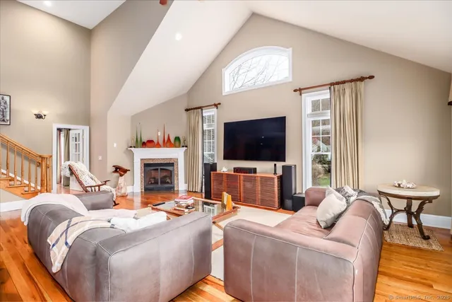 a living room with fireplace furniture and a flat screen tv