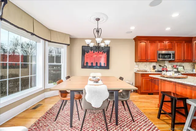 a dining room with furniture a rug and a chandelier