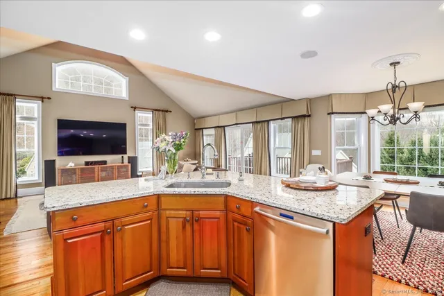 a kitchen with a sink and a large mirror