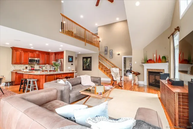a living room with furniture a fireplace and a flat screen tv