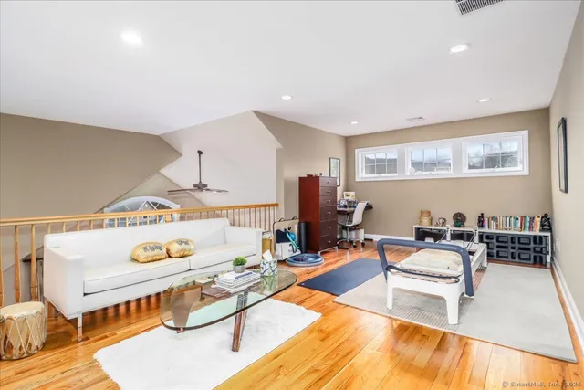 a living room with furniture a table and a flat screen tv