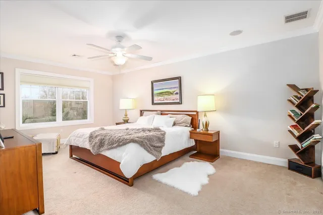 a bedroom with a bed and a book shelf