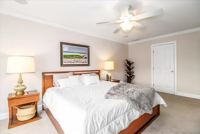 a bedroom with a bed and a painting on the wall