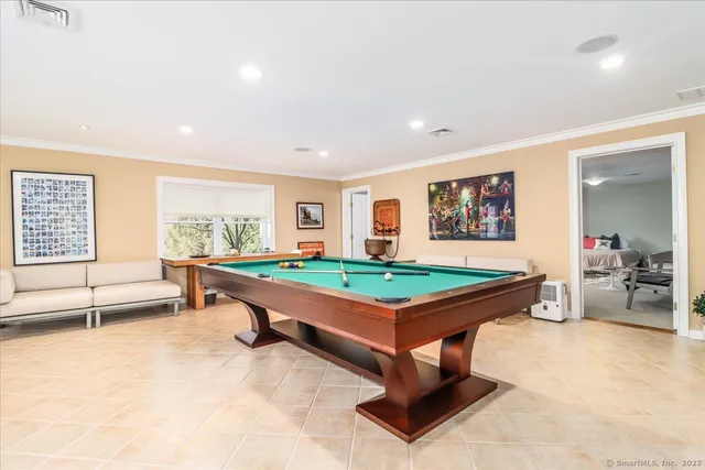 a room with pool table and windows