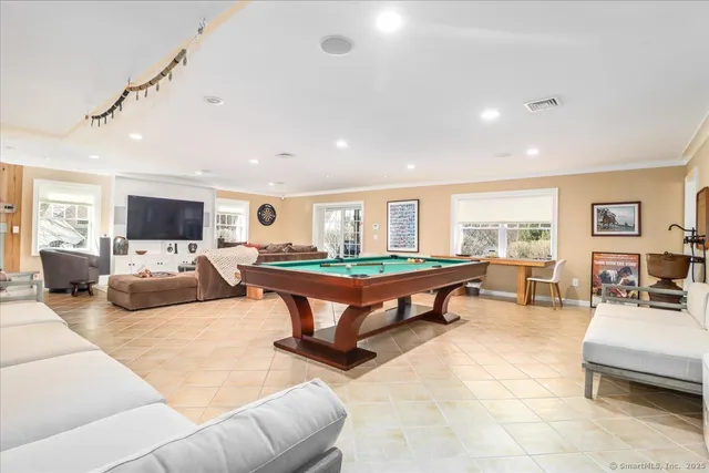 a living room with furniture a table and a flat screen tv