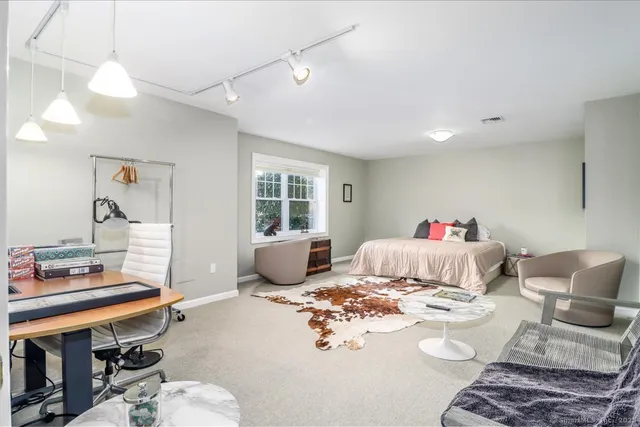 a large bedroom with a large bed and a large window