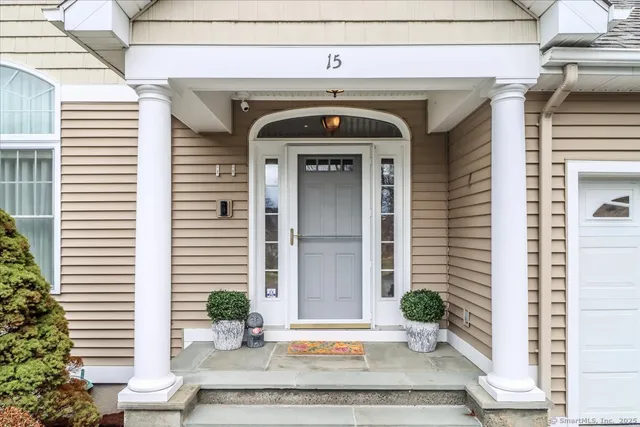 a front view of a house with potted plants