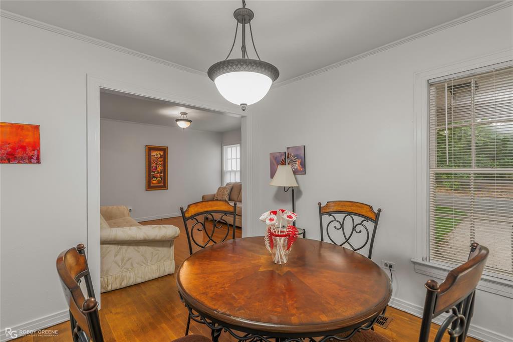 515 Davis Street Minden, LA 71055 - Photo 12 of 28 a dining room with furniture a wooden floor and a chandelier