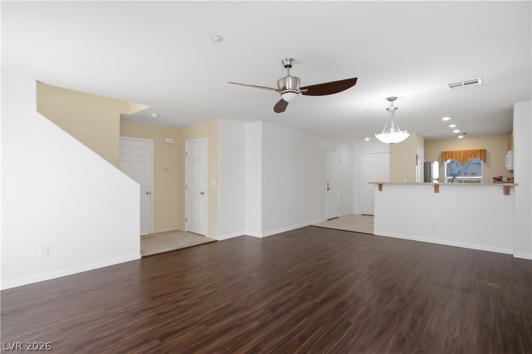 1172 Gecko Road Henderson, NV 89002 - Photo 7 of 30 A versatile open-concept living space features rich vinyl laminate flooring and abundant natural light.
