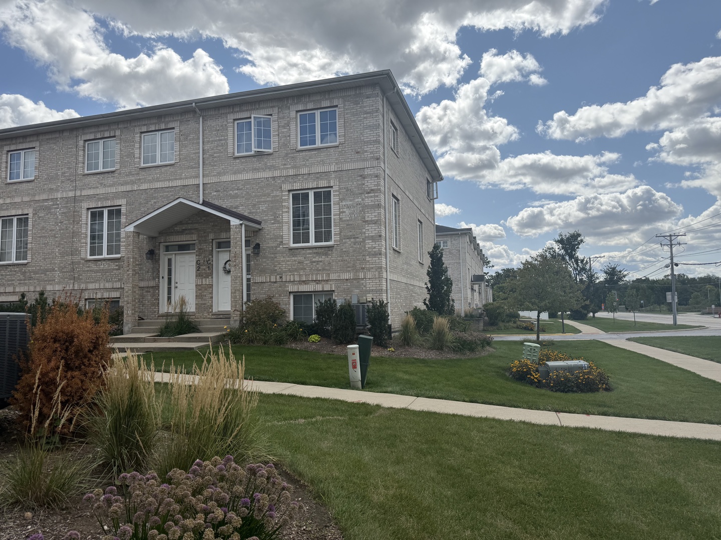 183 East River Road, Unit C1 Des Plaines, IL 60016 - Photo 2 of 25 a front view of a house with a yard