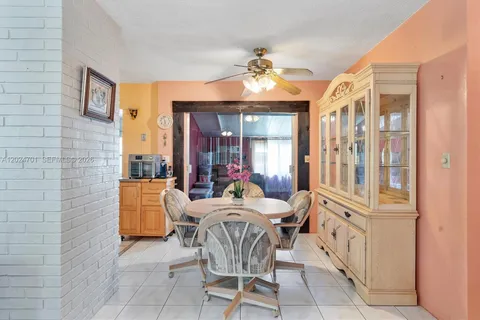 a dining room with furniture a chandelier and wooden floor