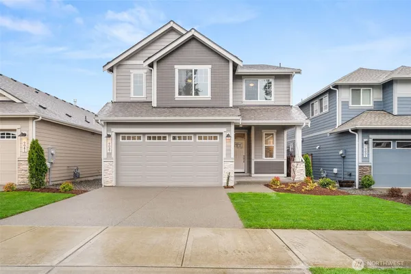 a front view of a house with a yard and garage