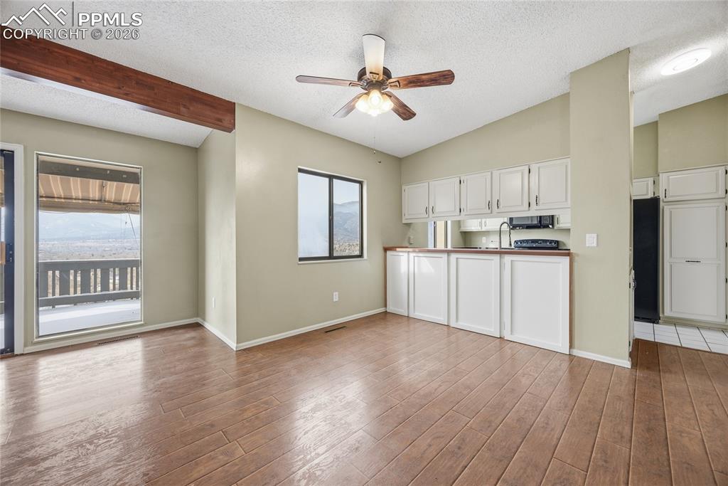 930 Fontmore Road, Unit C Colorado Springs, CO 80904 - Photo 11 of 32 a kitchen with stainless steel appliances kitchen island hardwood floor and a window