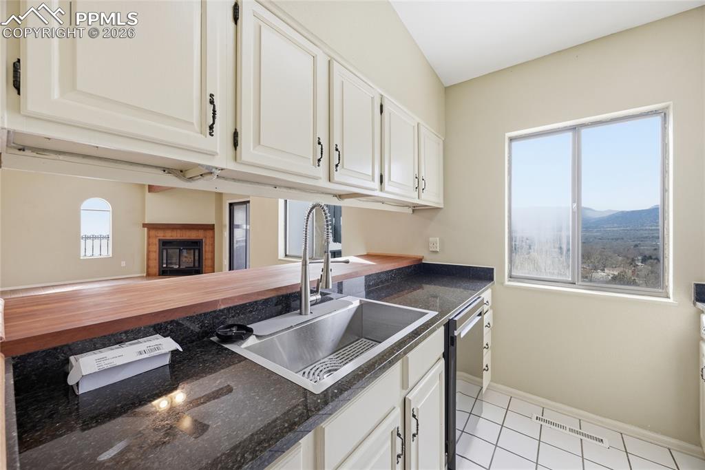 930 Fontmore Road, Unit C Colorado Springs, CO 80904 - Photo 13 of 32 a kitchen with stainless steel appliances granite countertop a sink and a white cabinets