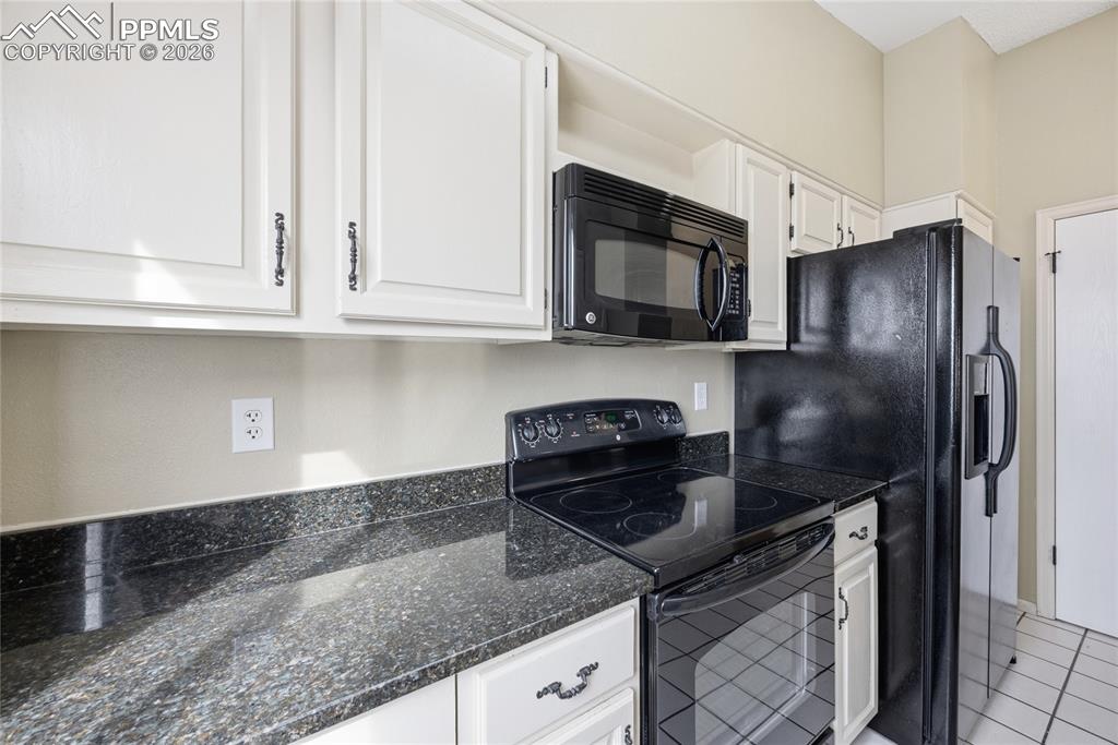 930 Fontmore Road, Unit C Colorado Springs, CO 80904 - Photo 14 of 32 a kitchen with granite countertop a sink stove and refrigerator