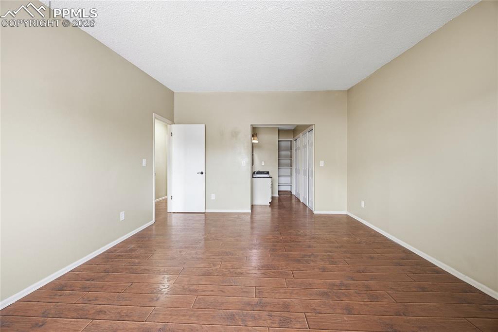 930 Fontmore Road, Unit C Colorado Springs, CO 80904 - Photo 17 of 32 a view of an empty room with wooden floor and a window