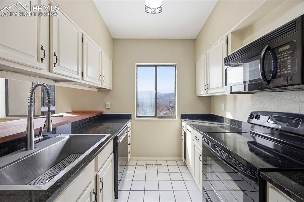 930 Fontmore Road, Unit C Colorado Springs, CO 80904 - Photo 2 of 32 a kitchen with granite countertop a sink stove and cabinets