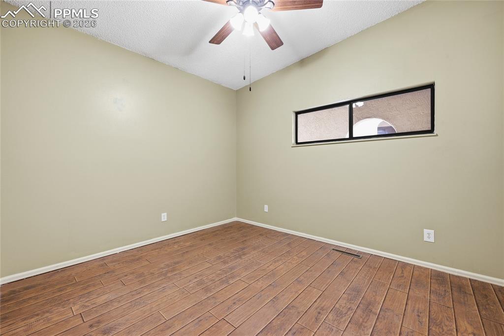 930 Fontmore Road, Unit C Colorado Springs, CO 80904 - Photo 21 of 32 a view of a room with wooden floor and white walls