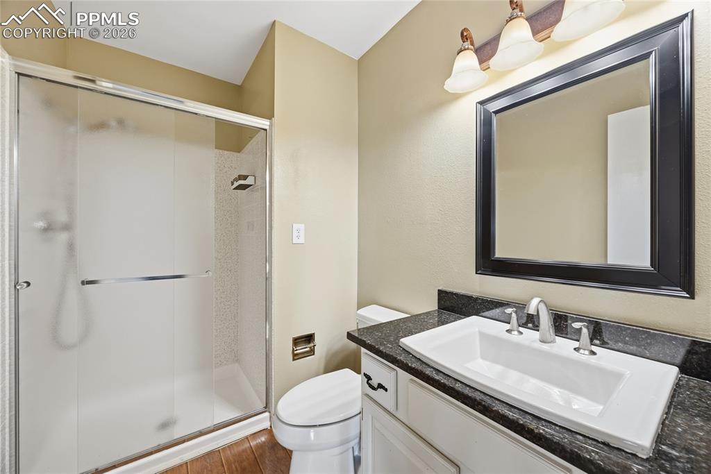 930 Fontmore Road, Unit C Colorado Springs, CO 80904 - Photo 26 of 32 a bathroom with a granite countertop sink toilet and shower