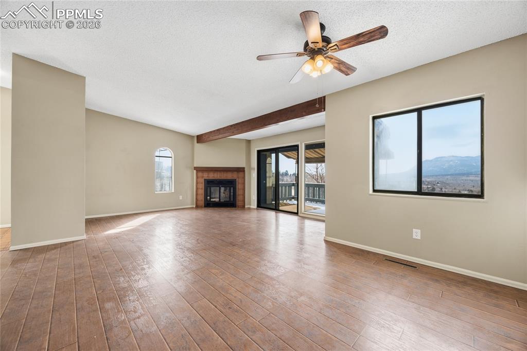 930 Fontmore Road, Unit C Colorado Springs, CO 80904 - Photo 3 of 32 a view of an empty room with window and wooden floor