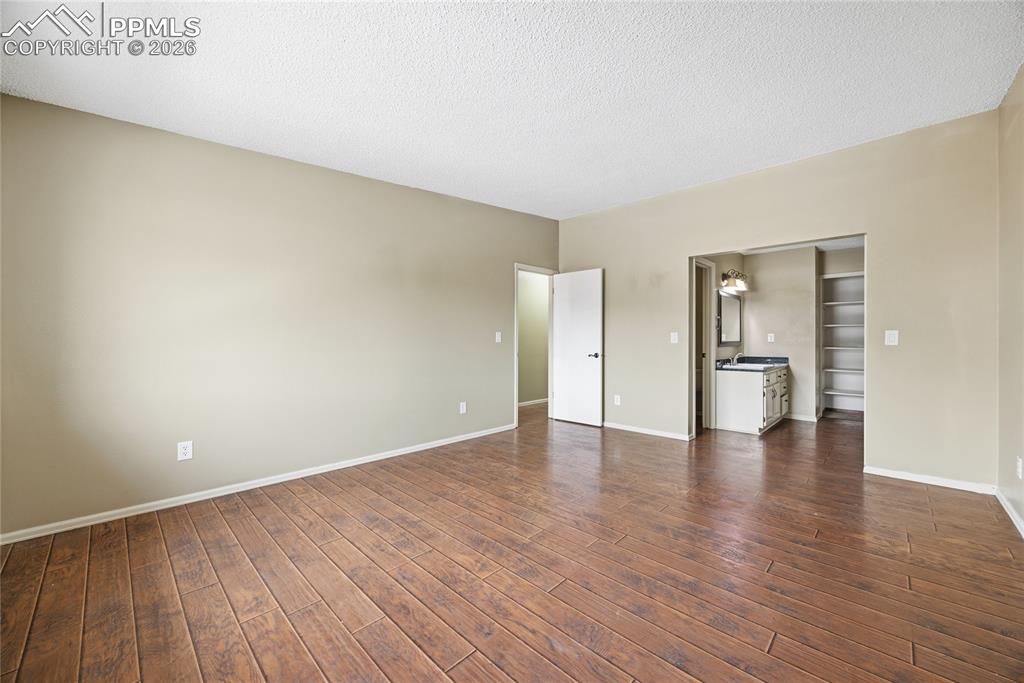 930 Fontmore Road, Unit C Colorado Springs, CO 80904 - Photo 4 of 32 a view of an empty room with wooden floor and a window