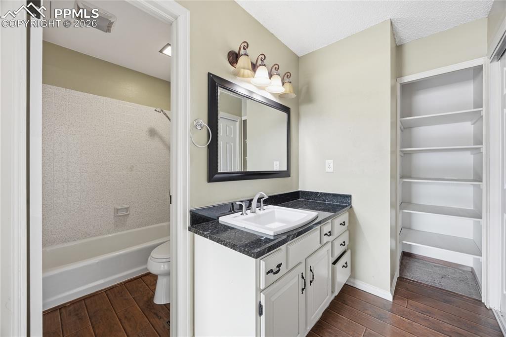 930 Fontmore Road, Unit C Colorado Springs, CO 80904 - Photo 6 of 32 a bathroom with a granite countertop sink a mirror and a bathtub