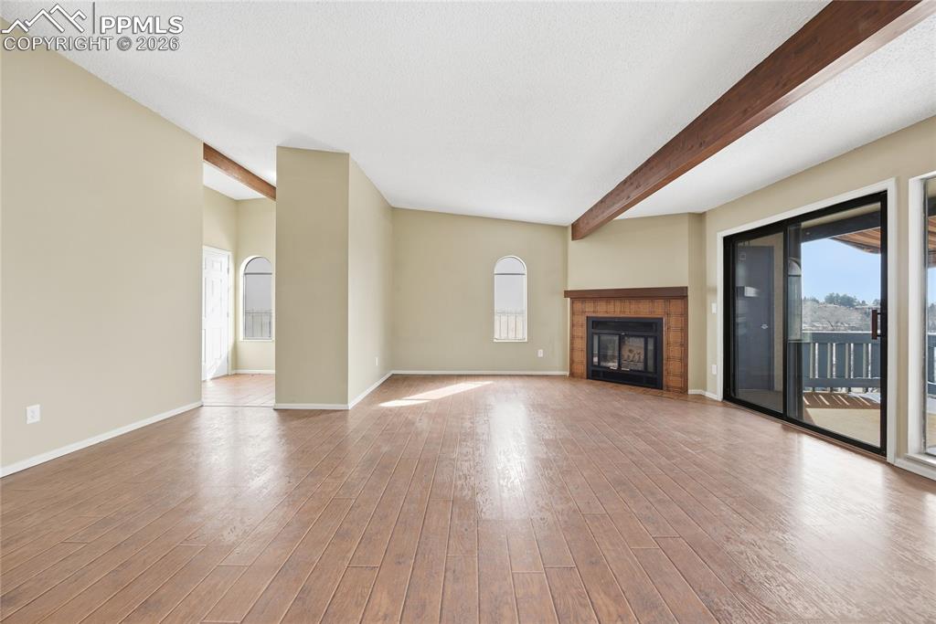 930 Fontmore Road, Unit C Colorado Springs, CO 80904 - Photo 9 of 32 a view of an empty room with wooden floor and a window