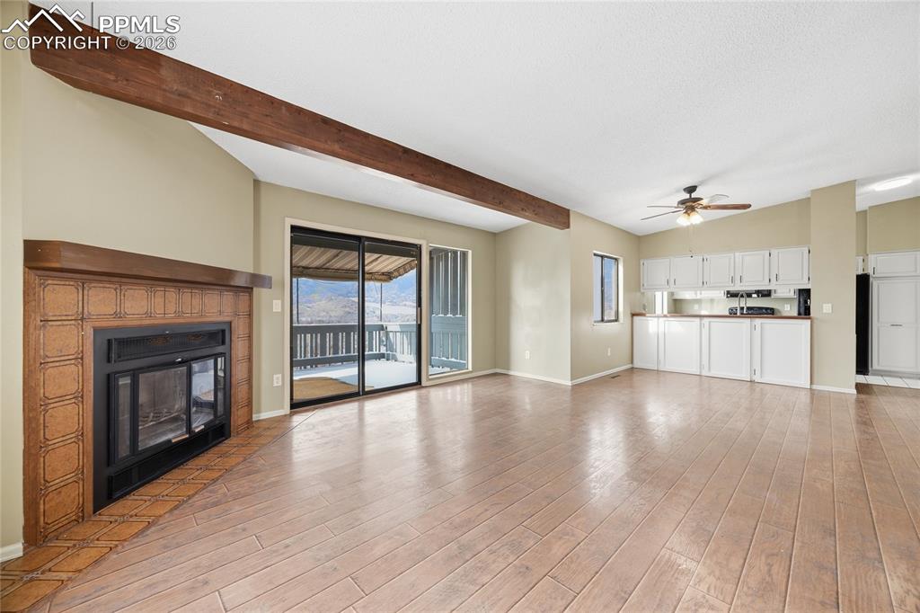 930 Fontmore Road, Unit C Colorado Springs, CO 80904 - Photo 10 of 32 a view of a livingroom with wooden floor and a fireplace