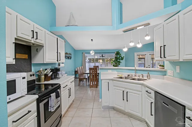 a kitchen with a sink stove and cabinets