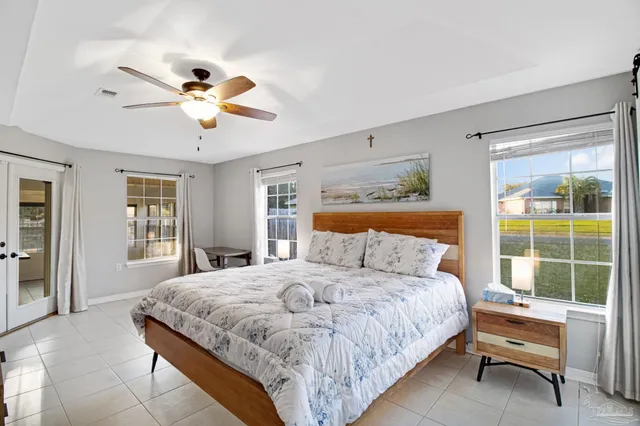 a bedroom with a large bed and a window