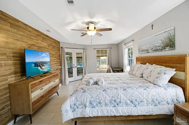 a bedroom with a bed and a flat screen tv