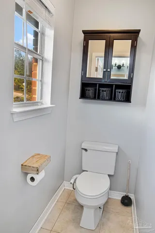 a bathroom with a toilet a sink and a window