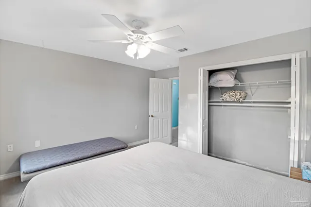 a bedroom with a bed and cabinets