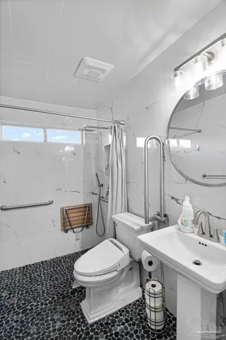 a bathroom with a sink toilet and shower