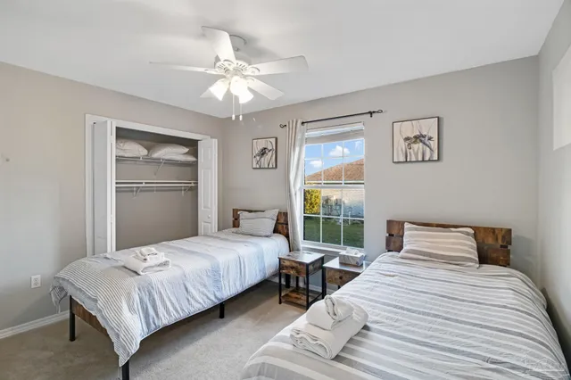 a bedroom with a large bed and a window
