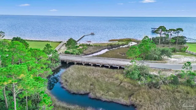 an aerial view of a house with a yard and lake view