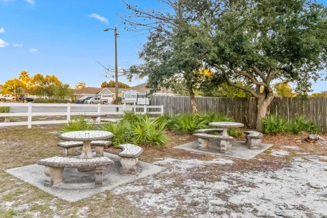 a view of a swimming pool with a patio and a yard
