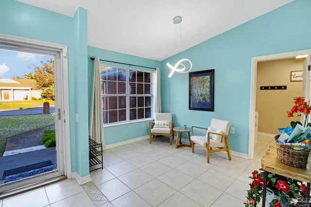 a living room with furniture and a floor to ceiling window