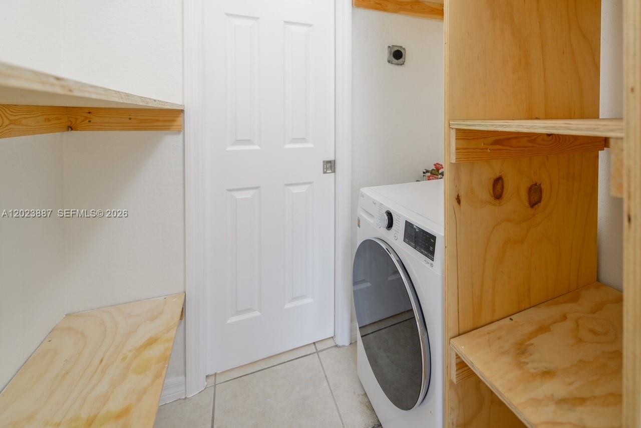 7737 Southwest 88th Street, Unit C312 Miami, FL 33156 - Photo 25 of 32 a bathroom with a sink a toilet and shower