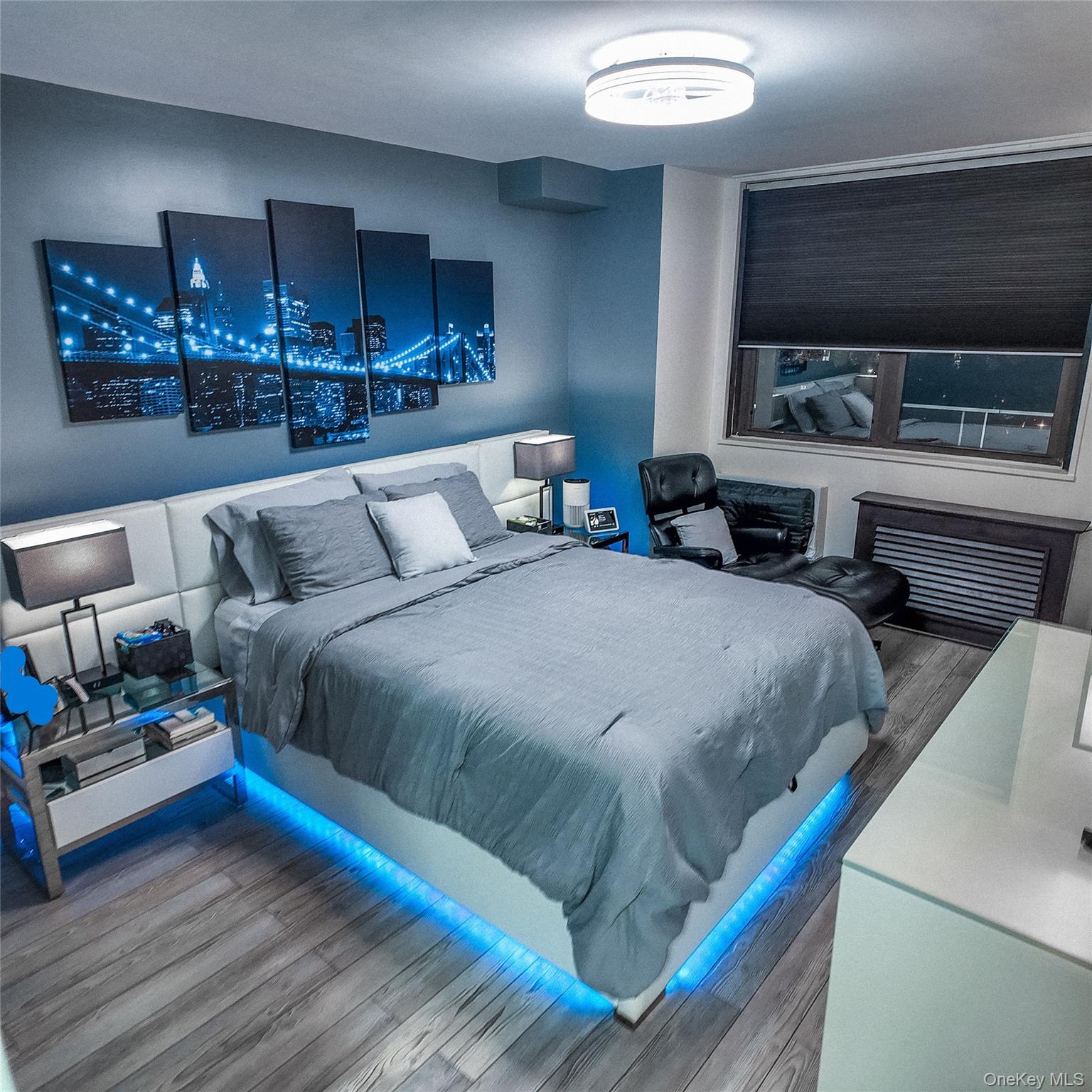 a bedroom with a bed a mirror and lamp