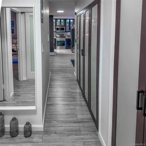 a view of a hallway with wooden floor and staircase