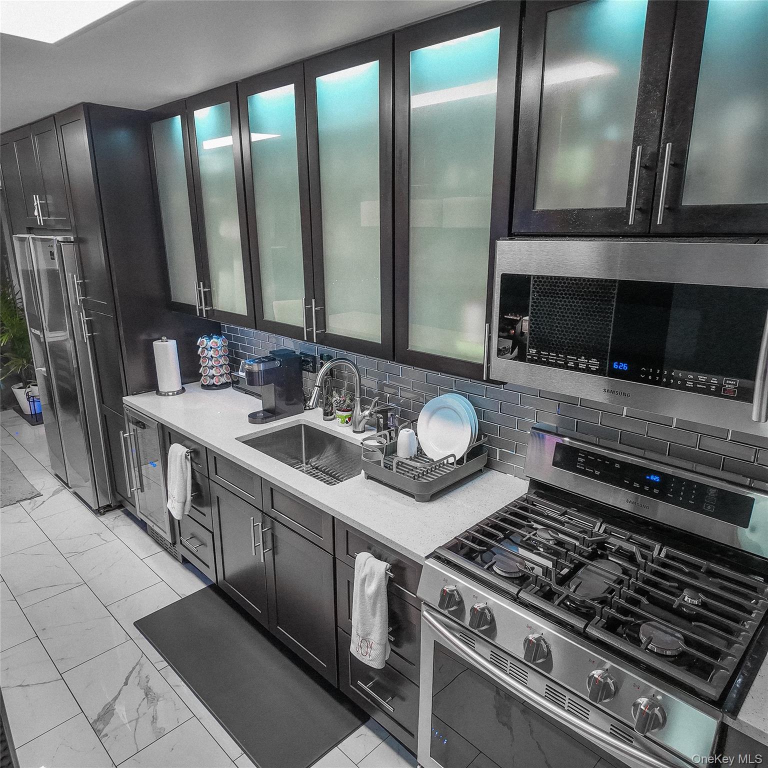 1966 Newbold Avenue, Unit 904 Bronx, NY 10472 - Photo 2 of 15 a kitchen with stainless steel appliances granite countertop a stove a sink and a microwave