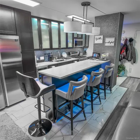 a kitchen with a dining table chairs sink and cabinets