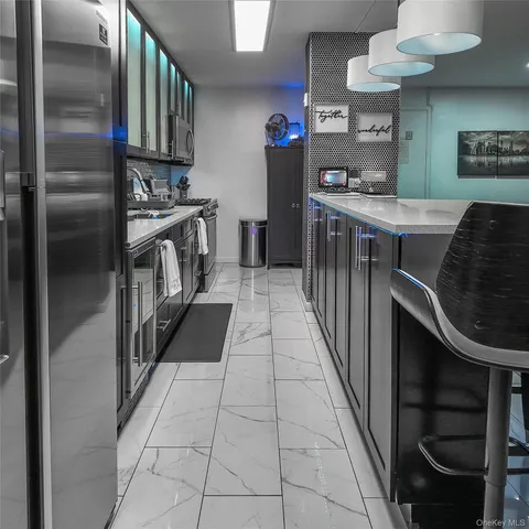 a kitchen with stainless steel appliances granite countertop a refrigerator and a stove