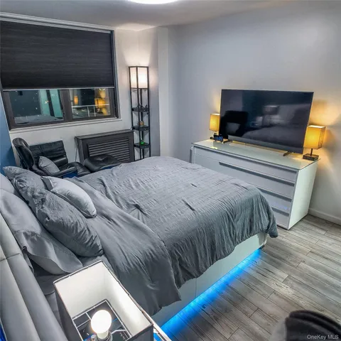 a bedroom with a bed and a television