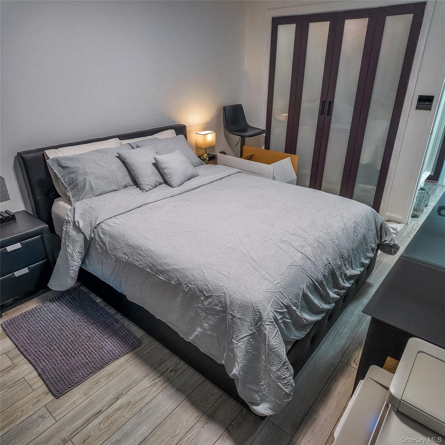 1966 Newbold Avenue, Unit 904 Bronx, NY 10472 - Photo 8 of 15 a bedroom with a bed and wooden floor