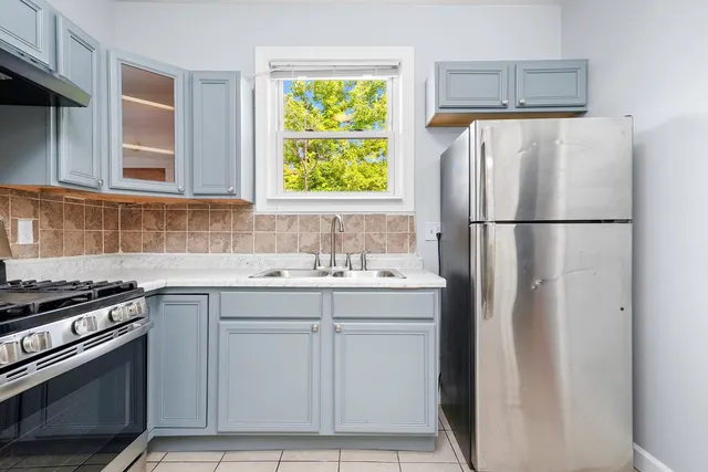 a kitchen with appliances a sink and a window