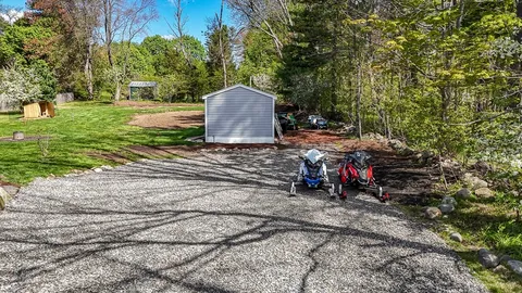 a view of a wooden house with a yard
