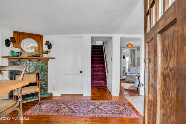 a view of room with furniture and wooden floor